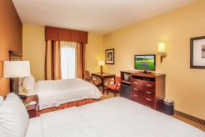 a hotel room with two beds and a flat screen tv at Hampton Inn & Suites Sevierville at Stadium Drive in Kodak