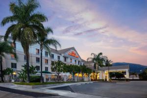 a hotel with palm trees in front of a building at Hilton Garden Inn Arcadia/Pasadena Area in Arcadia