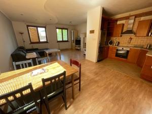 a kitchen and living room with a table and chairs at Dom Príbovce in Príbovce