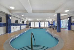 a large swimming pool in a large building at Homewood Suites by Hilton Burlington in Burlington