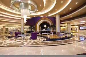 a hotel lobby with purple chairs and tables at Limak Eurasia Luxury Hotel in Istanbul