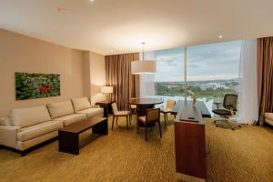 una sala de estar con un sofá y una mesa en Hilton Garden Inn Puebla Angelopolis, en Puebla