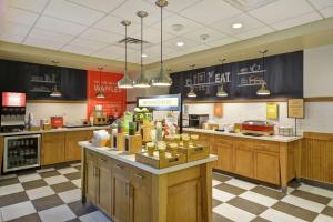 a kitchen with wooden cabinets and a counter in a store at Hampton Inn & Suites Dallas/Plano-East in Plano