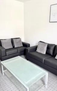 a living room with a couch and a coffee table at Convenient & Modern Private Bedroom Space near Barnsley Hospital in Barnsley