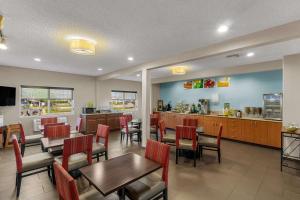 a restaurant with tables and chairs and a counter at Quality Inn Denver Northeast Brighton in Brighton