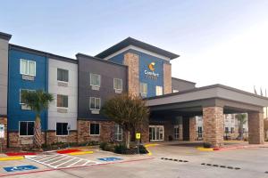 a hotel building with a parking lot in front of it at Comfort Suites Seabrook - Kemah in Seabrook