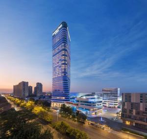 a tall building in a city at night at Doubletree by Hilton Foshan Nanhai-Free Canton Fair Shuttle Bus in Foshan