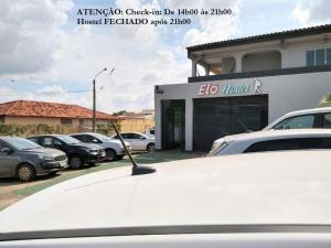 a car is parked in front of a dealership at Elô Hostel in Brasília