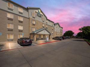 a rendering of a hotel with a parking lot at WoodSpring Suites Dallas Rockwall in Rockwall