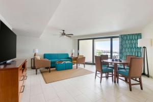 a living room with a blue couch and a table at Hilton Vacation Club Royal Palm St Maarten in Simpson Bay