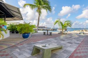 a patio with a bench and palm trees and the ocean at Hilton Vacation Club Royal Palm St Maarten in Simpson Bay