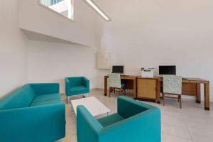 an office with blue chairs and a desk and a table at Hilton Vacation Club Royal Palm St Maarten in Simpson Bay