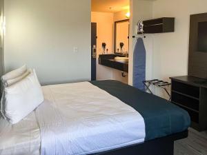 a bedroom with a bed and a sink in a room at Studio 6 Suites Delano, CA in Delano