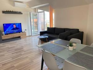 a living room with a couch and a table at Hancho - Velingrad - Marvel Apartament in Velingrad