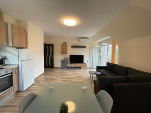 a living room with a couch and a table at Hancho - Velingrad - Marvel Apartament in Velingrad
