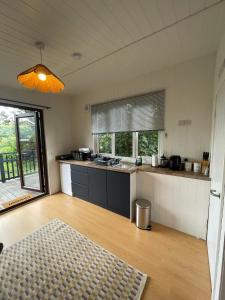 a kitchen with a counter top and a table at Pwllglas Bach - Spacious Cabin in Machynlleth