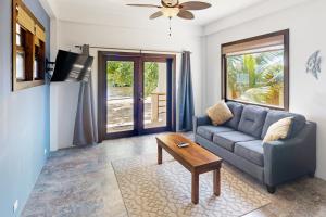 a living room with a couch and a coffee table at Suite 1 at Island Pearl Gold Standard Certified in Caye Caulker
