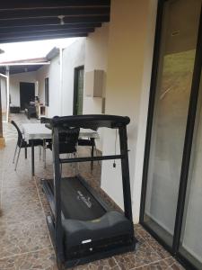 a room with a treadmill next to a table at Villa Namaste - Cabaña Albores in Curití
