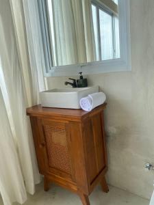 a bathroom sink with a mirror on top of it at Ulunia in Uluwatu +37 photos