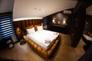 a bedroom with a large bed in a room at Kristall Apartments Premium in Šabac