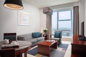 a living room with a couch and a table at The Mayflower, Jakarta-Marriott Executive Apartments in Jakarta