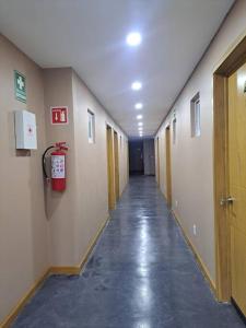 an empty hallway with a fire extinguisher on the wall at lugar cómodo para descansar²⁰⁷ in Fortín de las Flores