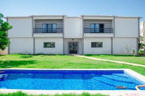 a house with a swimming pool in front of it at Residence Eliz in Kabrousse