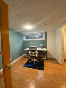 an office with a desk and a chair in a room at Spacious Guest house -walkout Basement- 4 guests! -dedicated workspace-No Pet! No Cooking! No Smoking! No Party! in Ottawa