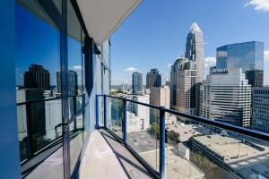 a balcony with a view of a city skyline at Uptown Furnished Apartments near BOA Stadium apts in Charlotte