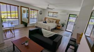 a living room with a bed and a couch at 'Stay in Carrara' A private guest suite not a share house in Gold Coast