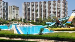 a swimming pool in a resort with a slide at Liparis3 holiday, beach,aquapark, in Erdemli