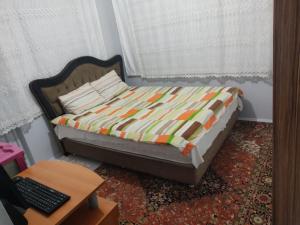 a bed in a room with a desk and a laptop at BE MY GUEST - Homestay ApartmentS Guest HouseS Sleeping Rooms in Antalya