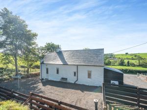 a white house with a fence in front of it at Lincumtoy in Ballantrae