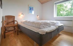 エーベルトフトにあるGorgeous Home In Ebeltoft With House Sea Viewのベッド1台(椅子、窓付)
