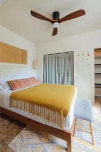 a bedroom with a bed and a ceiling fan at The Ohia at The Koi House in Kailua-Kona