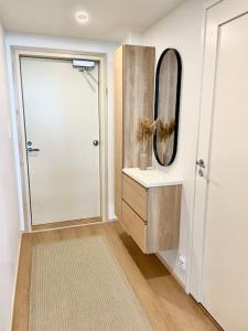 a bathroom with a shower and a sink and a mirror at Marina Sunset Resort A2 in Kalajoki