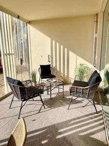 a group of chairs and a table on a patio at Marina Sunset Resort A2 in Kalajoki