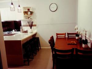 a kitchen with a table and some chairs and a counter at Wild Brumby- A cozy home away from home in Corryong