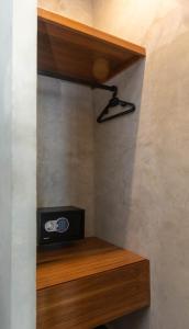 a room with a wooden shelf with a radio on it at Hotel Sun Ha Bacalar in Bacalar