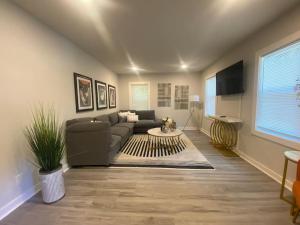 a living room with a couch and a table at East Point Atlanta - Spacious 5BR Retreat! in Atlanta