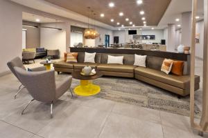 a living room with a couch and a table and chairs at SpringHill Suites Birmingham Colonnade in Birmingham