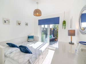 a bedroom with a bed with blue pillows on it at Seabreeze in Kinghorn