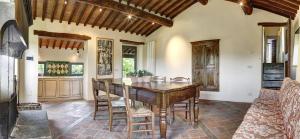 a dining room with a wooden table and chairs at Colombaio di Cencio in Gaiole in Chianti