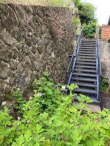 a set of stairs next to a stone wall at bungalow les cases près de la Mare à joncs in Cilaos