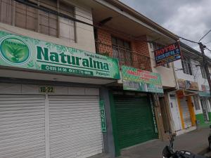 a building with green garage doors on a street at Hotel Casa Real 2 in Popayan