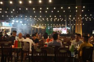 a group of people sitting in a restaurant at night at West Phu Quoc beach villa private swimming pool in Phú Quốc +127 photos