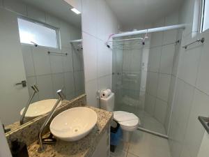 a bathroom with a toilet and a glass shower at Bela Hospedagem - #Wind Palace 606 Intermares in Cabedelo