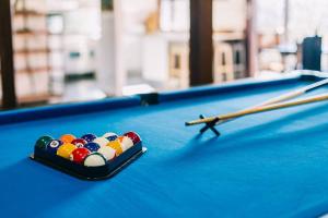 a cue stick on top of a pool table at BELLINGEN CONVERTED CHURCH on the river (Pet Friendly) in Bellingen