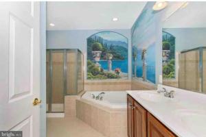 a bathroom with a painting of a tub and a sink at Open Floor Plan, Spa Tub, Fully Stocked Kitchen, King Bed in Frederick