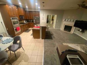 a large kitchen and living room with a table and chairs at Open Floor Plan, Spa Tub, Fully Stocked Kitchen, King Bed in Frederick